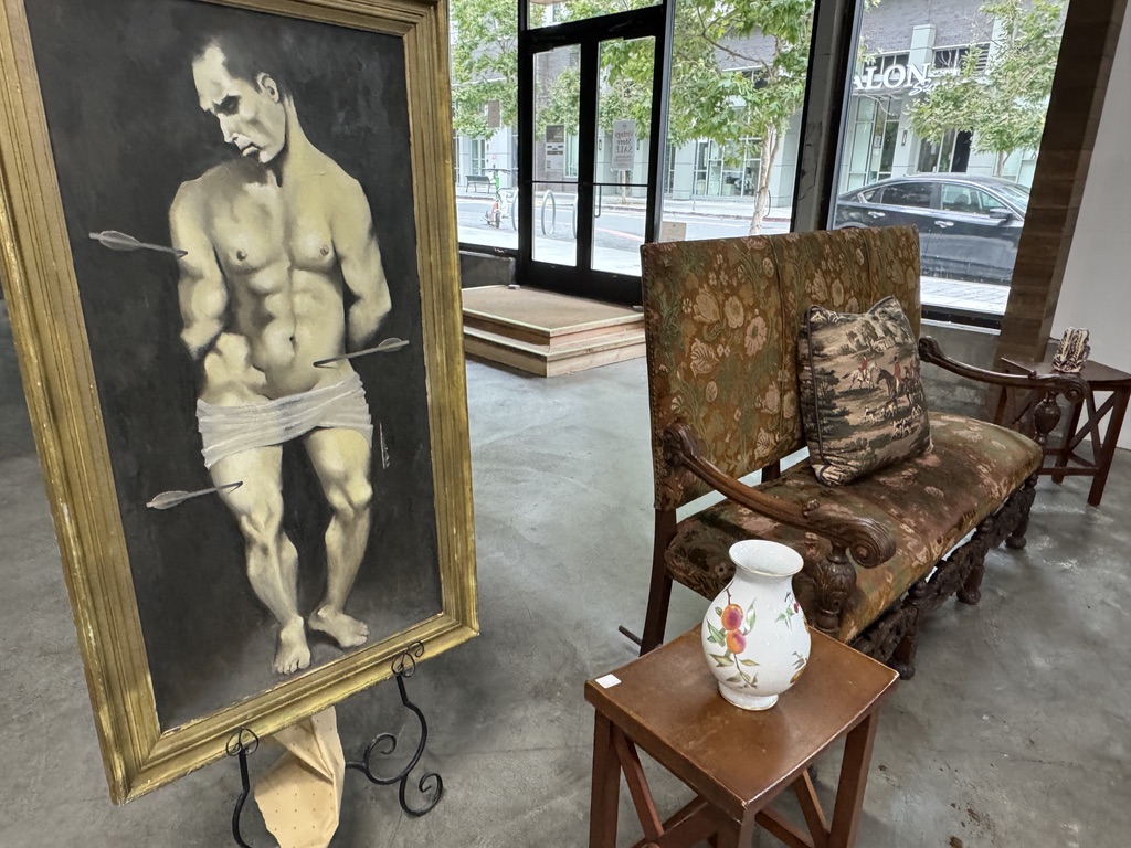 Framed artwork alongside vintage furniture