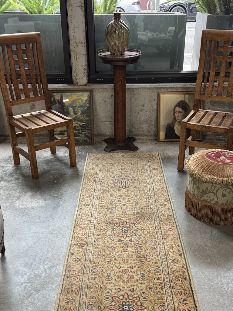 Wooden chairs, framed art, and a patterned rug