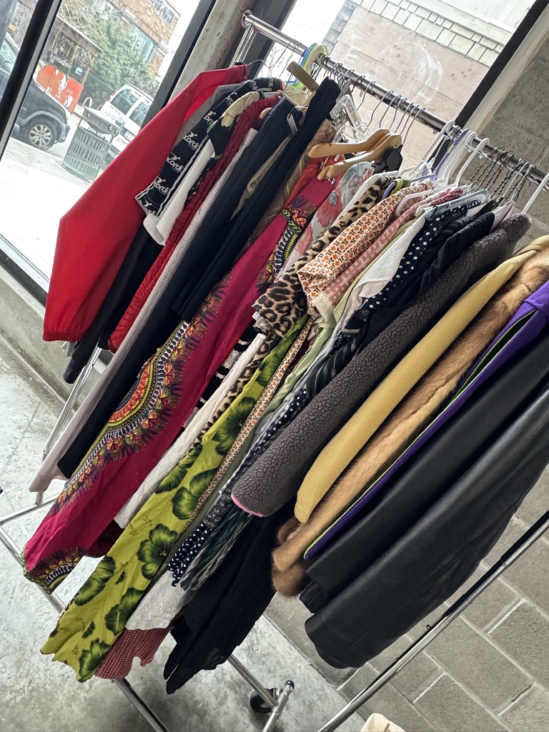 A rack of colorful vintage clothing