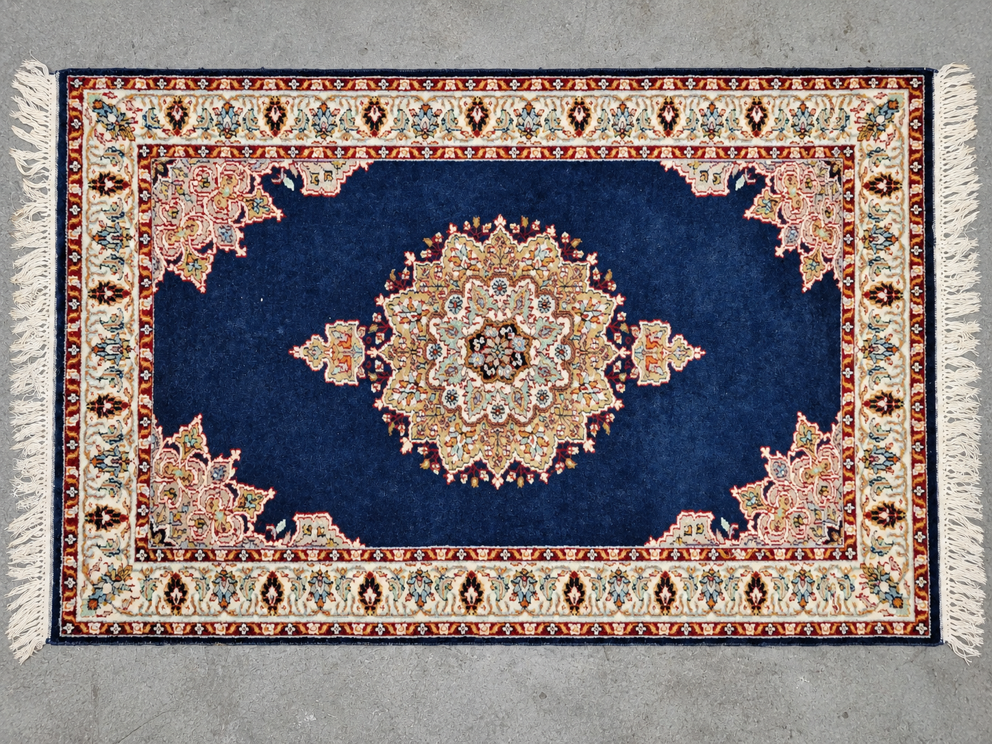 A richly patterned blue and ivory rug