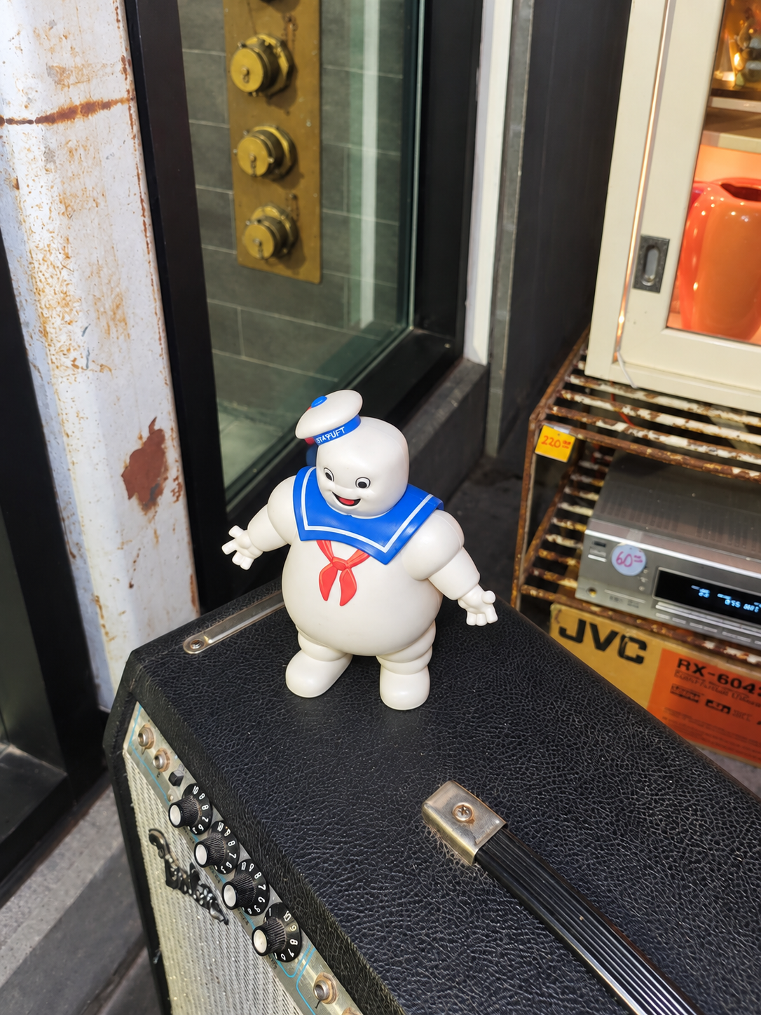 A Stay Puft figure displayed on a vintage amplifier