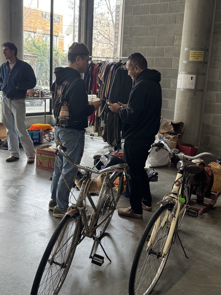 Shoppers chatting beside vintage bicycles